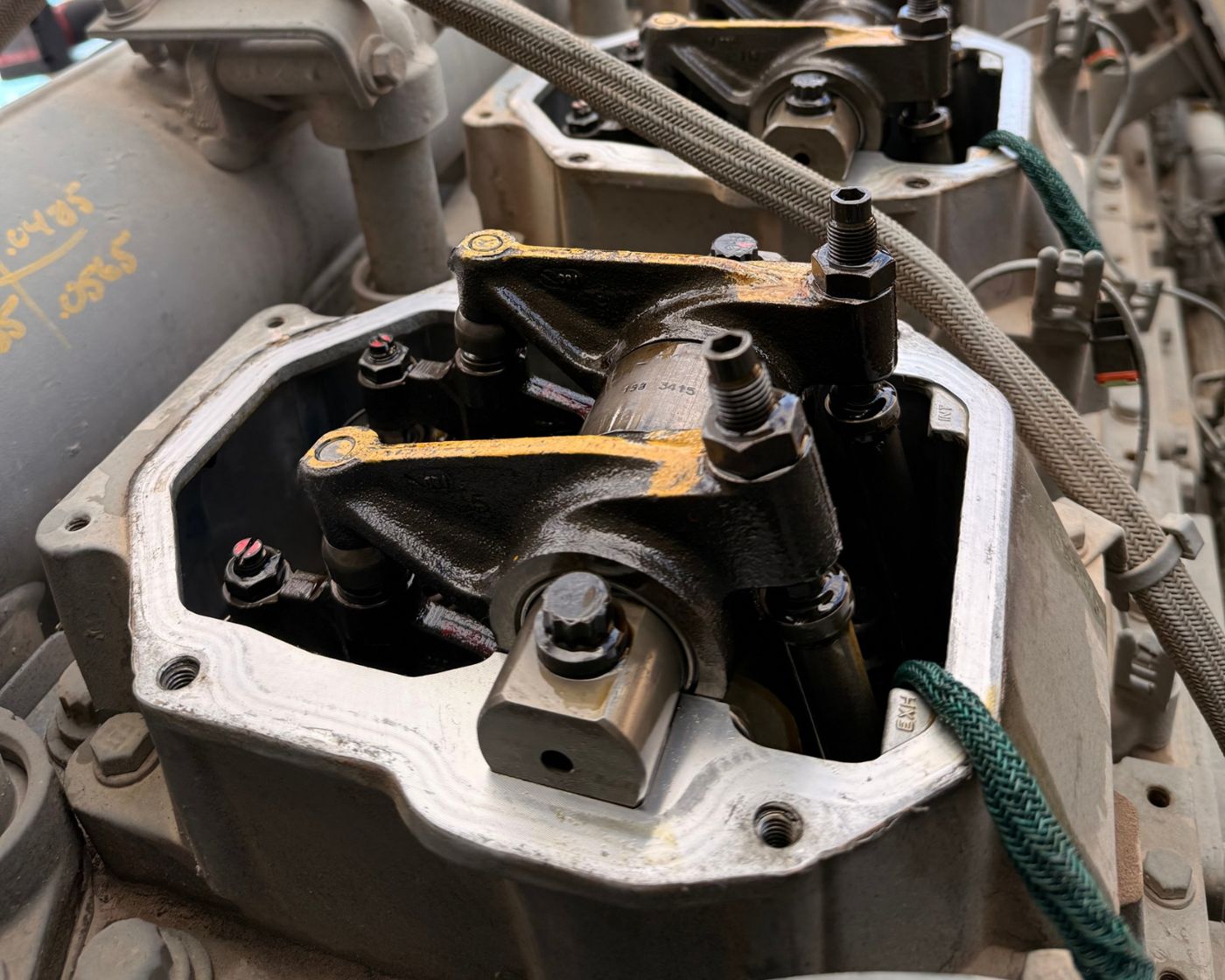 Gas engine with valve covers removed during service, showing rocker arms
